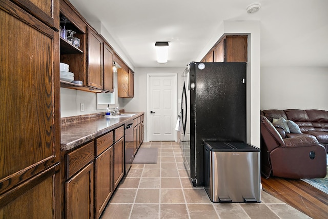 1274 Theresa Ln, Bourbonnais, IL 60914 - kitchen with open shelves, open floor plan, freestanding refrigerator, dark countertops, and stainless steel dishwasher