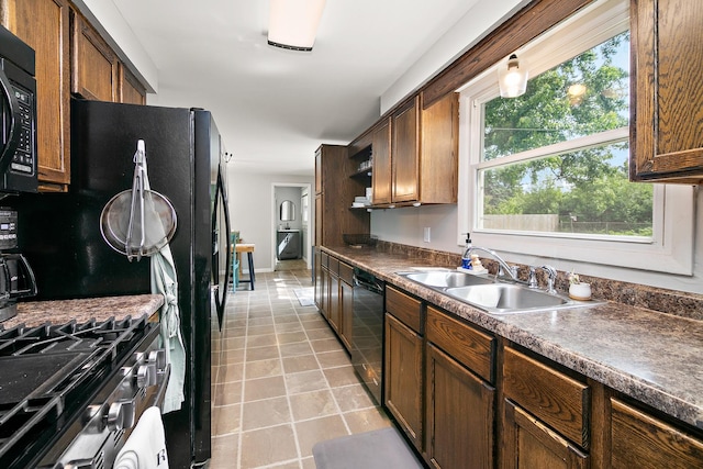 1274 Theresa Ln, Bourbonnais, IL 60914 - kitchen with a sink, black appliances, dark countertops, and light tile patterned flooring
