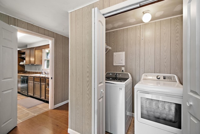 1274 Theresa Ln, Bourbonnais, IL 60914 - laundry room featuring separate washer and dryer, wood walls, and light wood finished floors