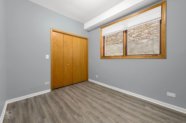 2711 W Congress Pkwy Unit 1, Chicago, IL 60612 - unfurnished bedroom with wood finished floors, baseboards, and a closet