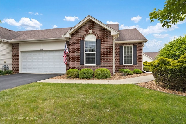 17016 Delevan St, Lockport, IL 60441 - view of front of house featuring brick siding, asphalt driveway, an attached garage, a front lawn, and a shingled roof