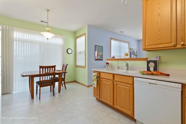 17016 Delevan St, Lockport, IL 60441 - kitchen featuring white dishwasher, a sink, light countertops, baseboards, and pendant lighting