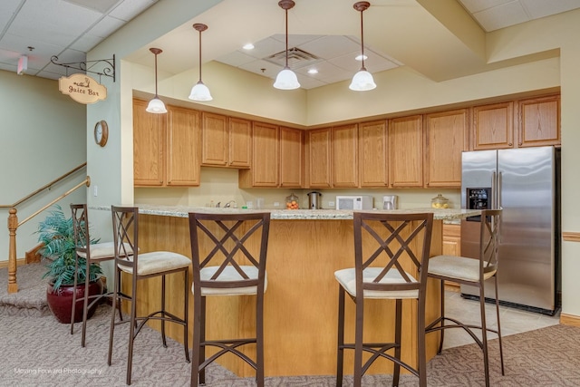 17016 Delevan St, Lockport, IL 60441 - kitchen with stainless steel refrigerator with ice dispenser, pendant lighting, a kitchen bar, and a paneled ceiling