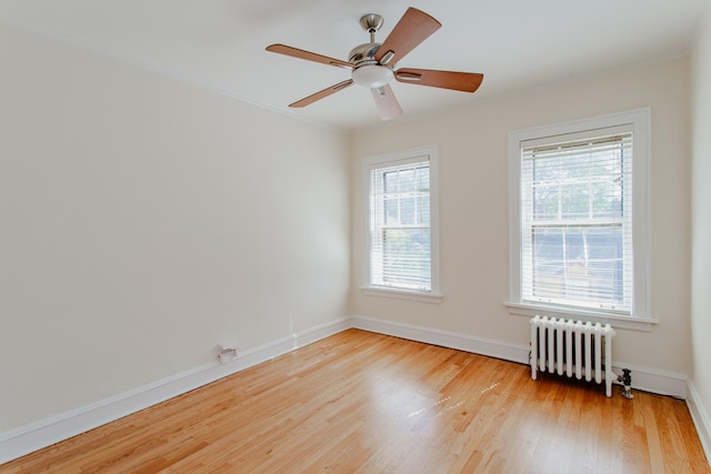 1929 Sherman Ave Unit 2E, Evanston, IL 60201 - spare room featuring radiator heating unit, light wood-style flooring, baseboards, crown molding, and ceiling fan
