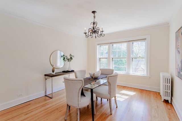 1929 Sherman Ave Unit 2E, Evanston, IL 60201 - dining area featuring radiator, a chandelier, light wood finished floors, ornamental molding, and baseboards