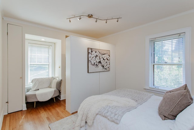 1929 Sherman Ave Unit 2E, Evanston, IL 60201 - bedroom with multiple windows, light wood finished floors, and ornamental molding