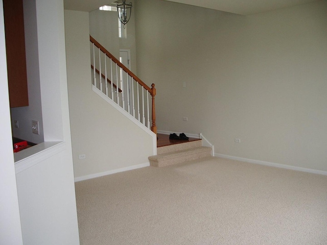 stairs with carpet floors and baseboards