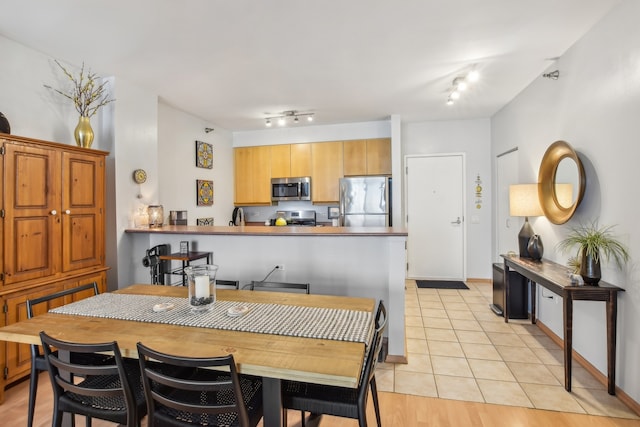 330 N Jefferson St Unit 1002, Chicago, IL 60661 - dining room featuring rail lighting and light tile patterned flooring