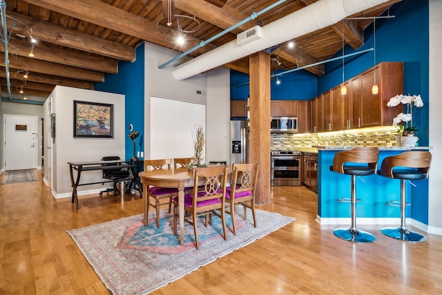 225 W Huron St Unit 413, Chicago, IL 60654 - dining area with wooden ceiling with exposed beams, light wood finished floors, baseboards, and a high ceiling