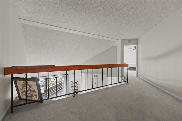 706 Waukegan Rd Unit 403C, Glenview, IL 60025 - hall featuring carpet, a textured ceiling, baseboards, and vaulted ceiling