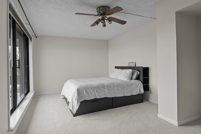 706 Waukegan Rd Unit 403C, Glenview, IL 60025 - bedroom with carpet, a textured ceiling, baseboards, and a ceiling fan