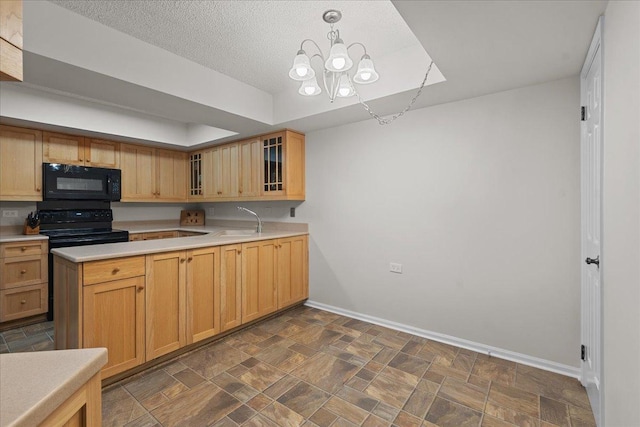 706 Waukegan Rd Unit 403C, Glenview, IL 60025 - kitchen with black appliances, a sink, baseboards, light countertops, and a textured ceiling