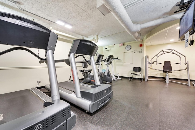 1560 N Sandburg Ter Unit 2704, Chicago, IL 60610 - workout area featuring a textured ceiling