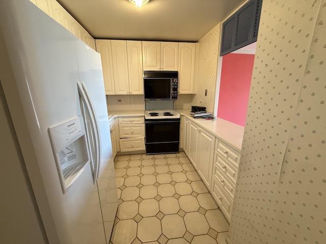 1560 N Sandburg Ter Unit 2704, Chicago, IL 60610 - kitchen with white fridge with ice dispenser, range with electric cooktop, black microwave, light countertops, and white cabinets