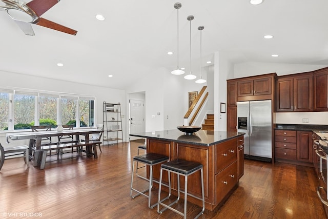 137 Hiawatha Trl, Highland Park, IL 60035 - kitchen featuring appliances with stainless steel finishes, vaulted ceiling, a center island, a kitchen breakfast bar, and dark wood-style floors