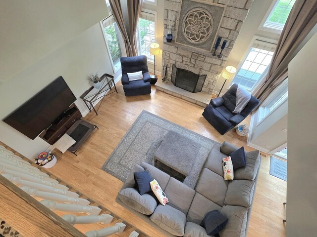 501 Siesta Dr, New Lenox, IL 60451 - living area featuring a stone fireplace, wood finished floors, and baseboards