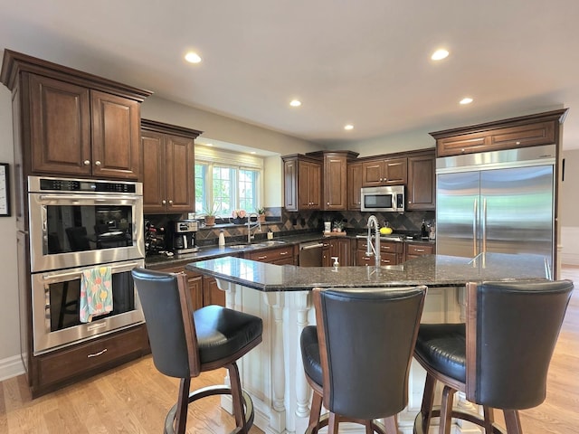 501 Siesta Dr, New Lenox, IL 60451 - kitchen with appliances with stainless steel finishes, tasteful backsplash, recessed lighting, an island with sink, and a sink