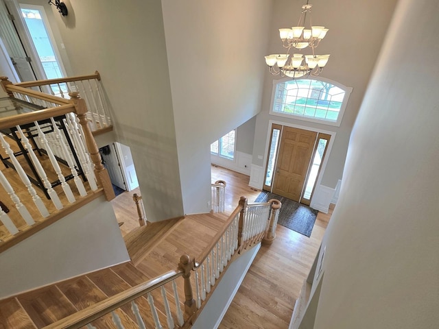 501 Siesta Dr, New Lenox, IL 60451 - foyer with a towering ceiling, wood finished floors, a chandelier, and stairway