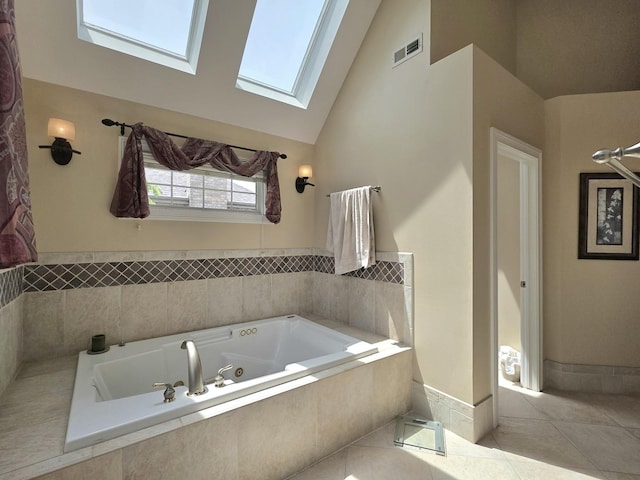 501 Siesta Dr, New Lenox, IL 60451 - full bath with a skylight, a whirlpool tub, tile patterned floors, high vaulted ceiling, and baseboards