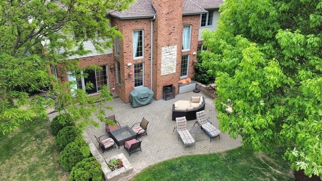 501 Siesta Dr, New Lenox, IL 60451 - rear view of house featuring an outdoor living space, a patio area, brick siding, and roof with shingles