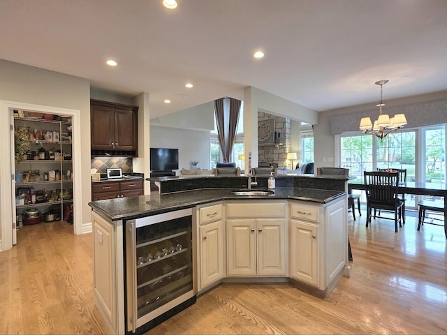 501 Siesta Dr, New Lenox, IL 60451 - kitchen with beverage cooler, open floor plan, a sink, light wood-type flooring, and recessed lighting