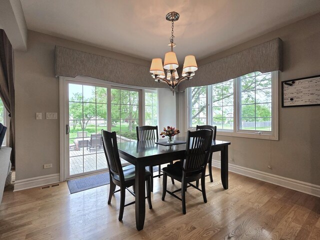 501 Siesta Dr, New Lenox, IL 60451 - dining room featuring baseboards, a chandelier, and light wood-type flooring