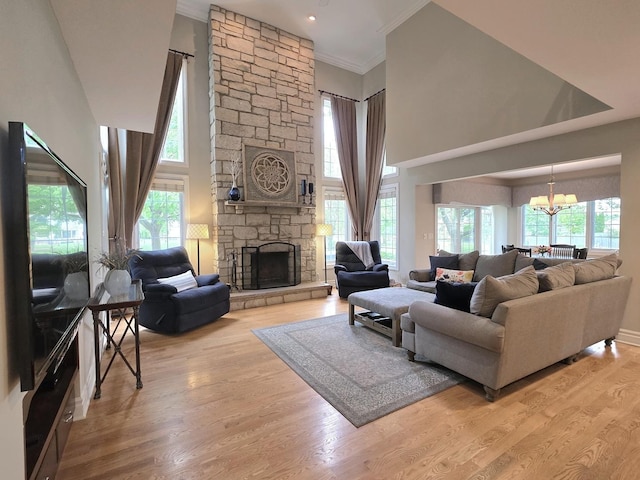 501 Siesta Dr, New Lenox, IL 60451 - living area featuring a chandelier, ornamental molding, wood finished floors, a fireplace, and a towering ceiling