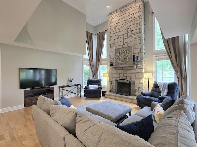 501 Siesta Dr, New Lenox, IL 60451 - living room with baseboards, a fireplace, light wood-style flooring, a towering ceiling, and crown molding
