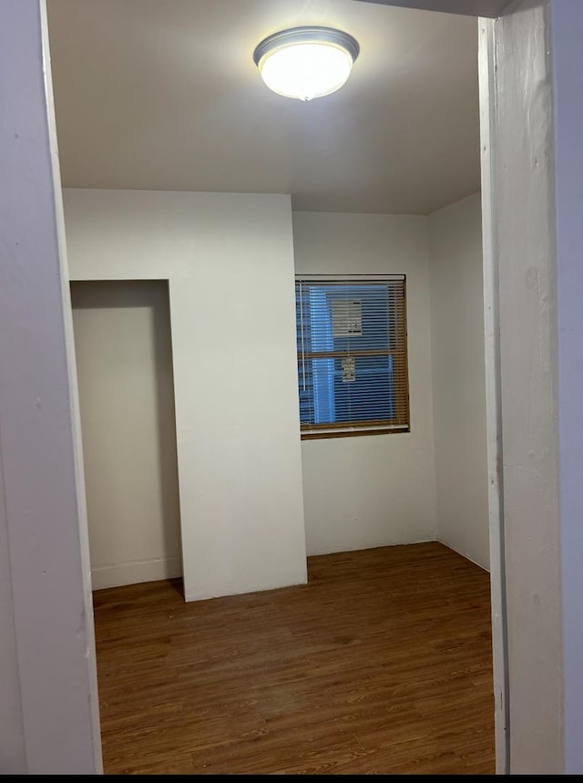 empty room with wood finished floors