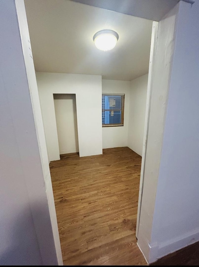 hallway with wood finished floors
