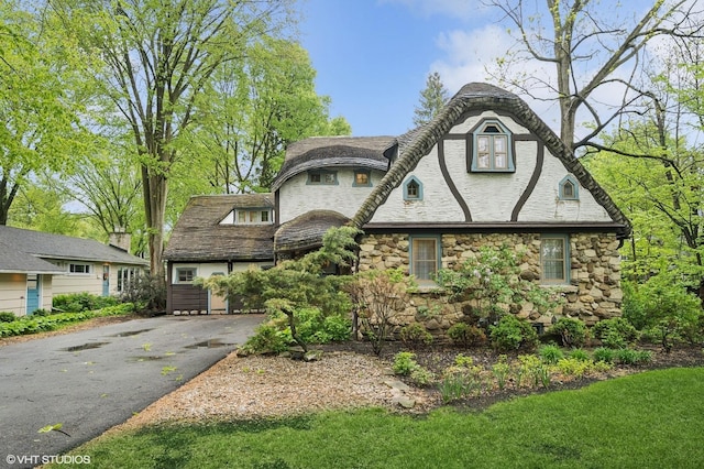 1487 Tower Rd, Winnetka, IL 60093 - view of front of home featuring stone siding and asphalt driveway