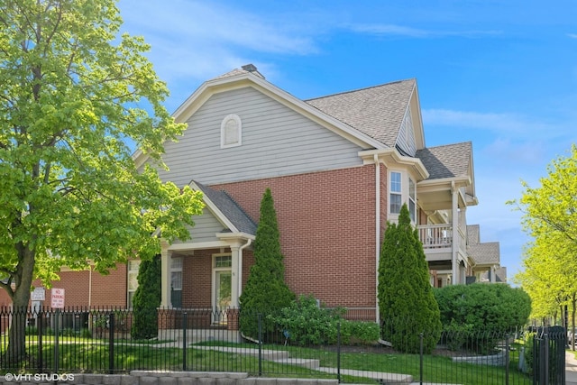 6247 Lincoln Ave Unit 6-3, Morton Grove, IL 60053 - view of side of property featuring brick siding, roof with shingles, and a fenced front yard