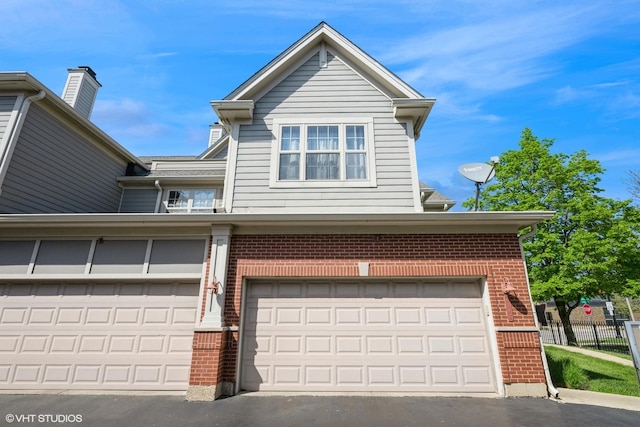 6247 Lincoln Ave Unit 6-3, Morton Grove, IL 60053 - view of front facade featuring brick siding and an attached garage