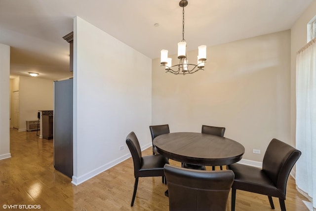 6247 Lincoln Ave Unit 6-3, Morton Grove, IL 60053 - dining area with a chandelier, light wood finished floors, and baseboards