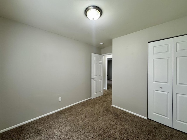 824 Dartmouth Ave, Matteson, IL 60443 - unfurnished bedroom featuring dark carpet, baseboards, and a closet