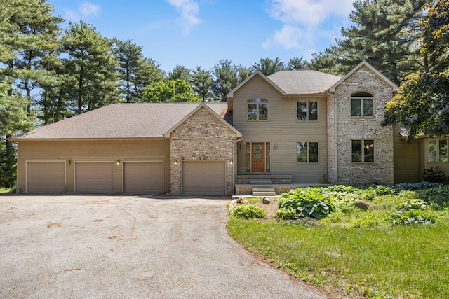 2946 County Road 800 E, Dewey, IL 61840 - view of front facade featuring driveway, an attached garage, brick siding, and a shingled roof