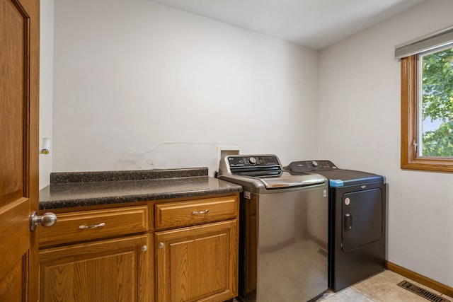 2946 County Road 800 E, Dewey, IL 61840 - laundry room featuring independent washer and dryer, cabinet space, light tile patterned floors, and baseboards