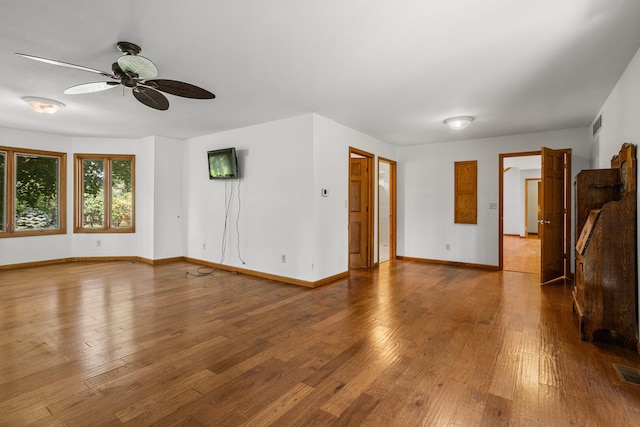 2946 County Road 800 E, Dewey, IL 61840 - unfurnished living room with a ceiling fan, wood finished floors, and baseboards