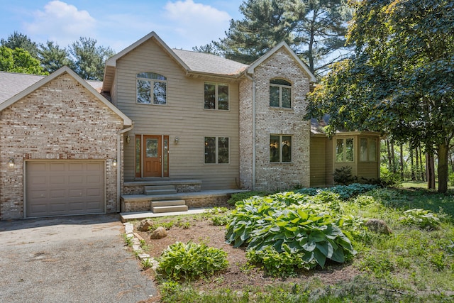 2946 County Road 800 E, Dewey, IL 61840 - view of front facade with an attached garage, brick siding, driveway, and a shingled roof