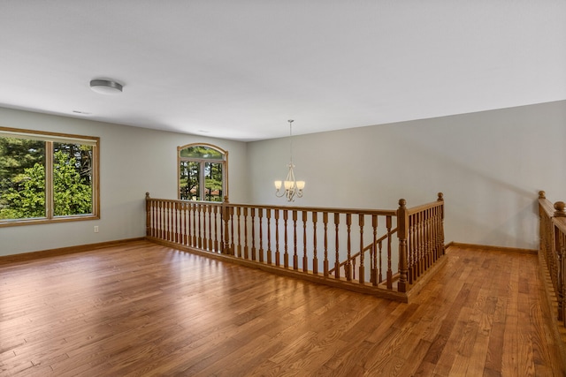 2946 County Road 800 E, Dewey, IL 61840 - unfurnished room with wood finished floors, a chandelier, and baseboards