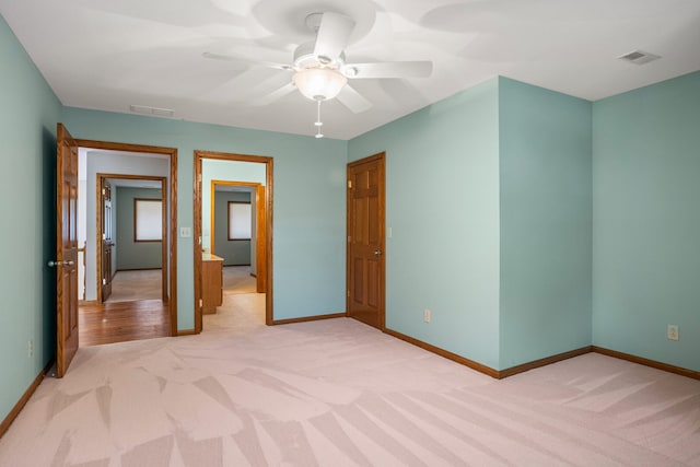2946 County Road 800 E, Dewey, IL 61840 - unfurnished bedroom featuring light colored carpet, baseboards, and ceiling fan