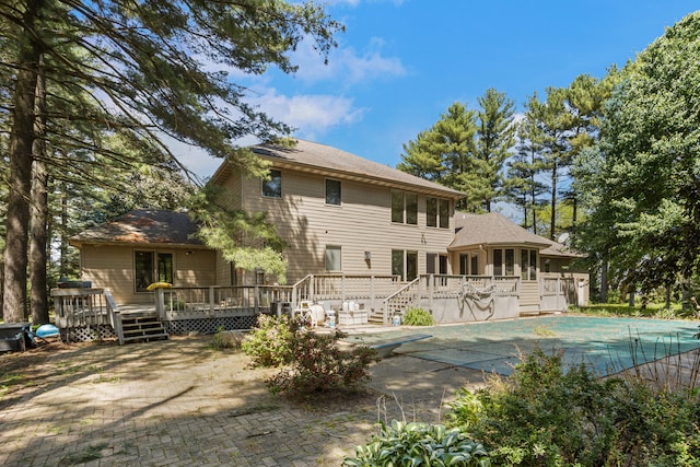 2946 County Road 800 E, Dewey, IL 61840 - back of house with a covered pool, a deck, a sunroom, and a patio