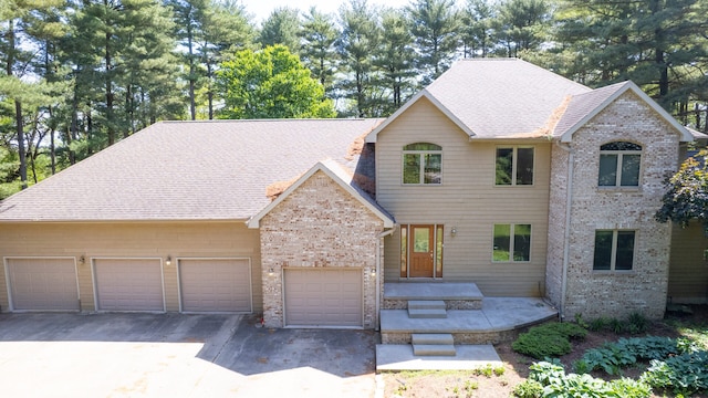 2946 County Road 800 E, Dewey, IL 61840 - view of front of house featuring brick siding, asphalt driveway, roof with shingles, and a garage