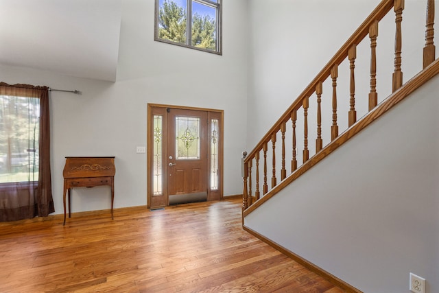 2946 County Road 800 E, Dewey, IL 61840 - entrance foyer with healthy amount of natural light, wood finished floors, stairs, a towering ceiling, and baseboards