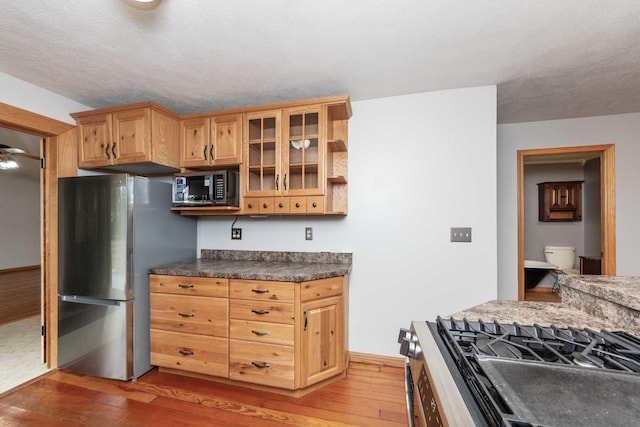 2725 2100n Rd, Minonk, IL 61760 - kitchen with stainless steel appliances, hardwood / wood-style flooring, dark countertops, and open shelves
