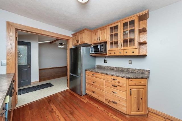 2725 2100n Rd, Minonk, IL 61760 - kitchen featuring appliances with stainless steel finishes, dark countertops, wood finished floors, and ceiling fan