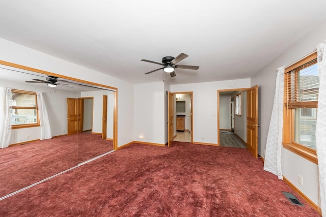 2725 2100n Rd, Minonk, IL 61760 - unfurnished bedroom with carpet, baseboards, a ceiling fan, and a closet