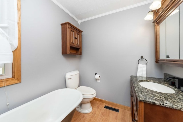 2725 2100n Rd, Minonk, IL 61760 - bathroom featuring wood finished floors, a freestanding bath, ornamental molding, vanity, and toilet