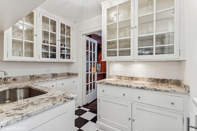1320 N State Pkwy Unit 2A, Chicago, IL 60610 - kitchen with a sink, white cabinets, dark floors, and light stone countertops