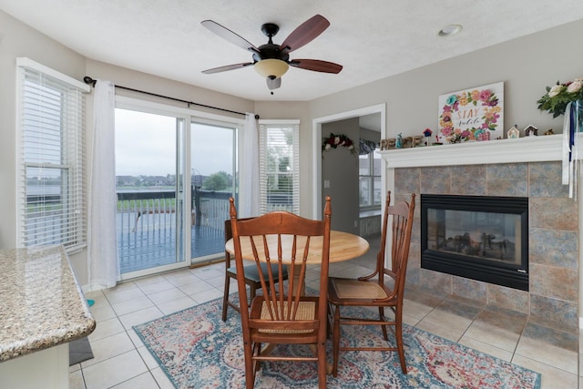 2738 Wharton Way, Normal, IL 61761 - dining room featuring ceiling fan, light tile patterned floors, and a fireplace